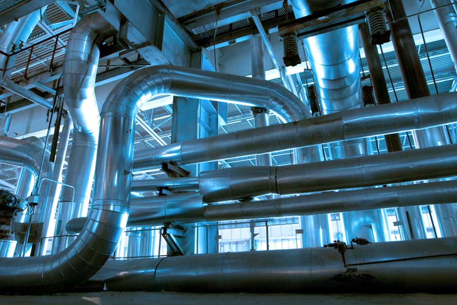 Industrial stainless steel pipework and ventilation ducting system in manufacturing facility infrastructure