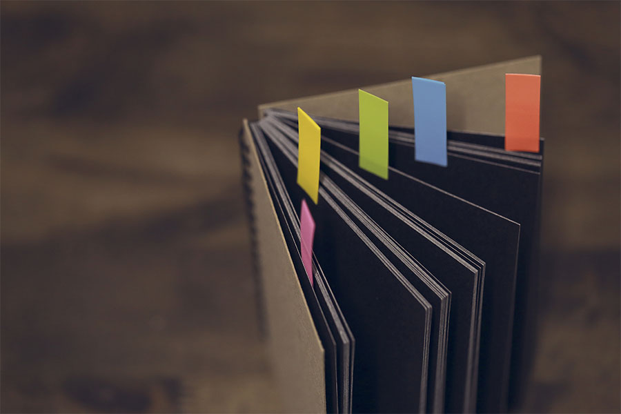 Organised technical documentation folder with coloured index tabs for research records and project filing system