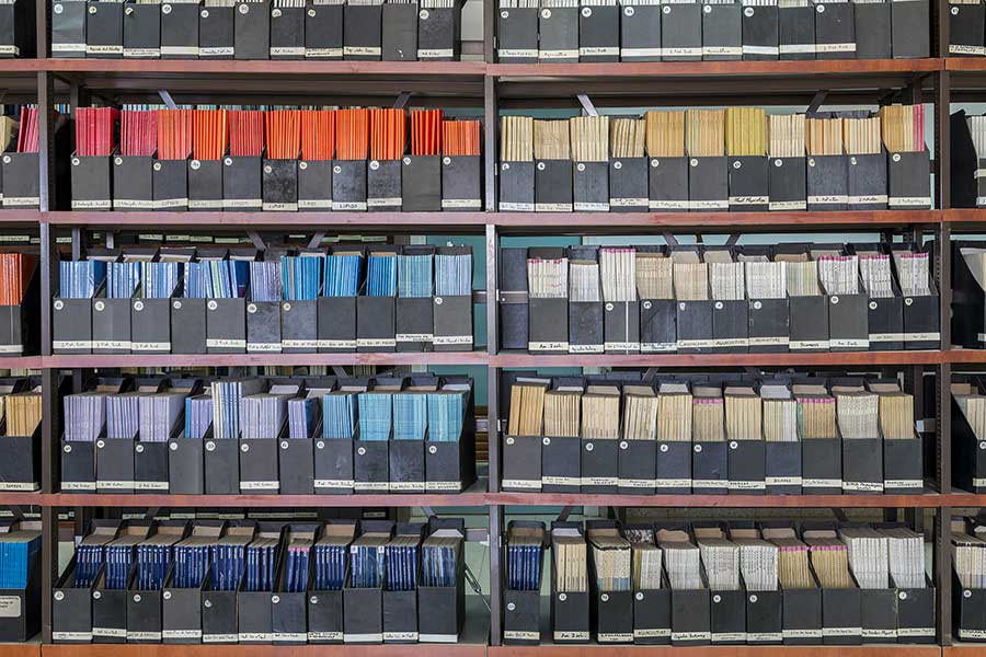Industrial archive shelving with labelled document binders and technical records storage in manufacturing facility