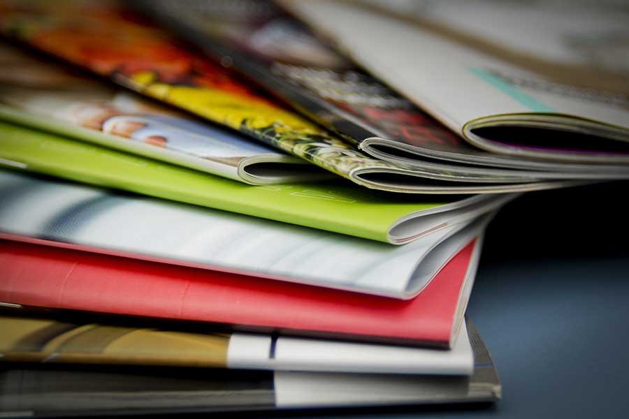 Stack of technical magazines and industry publications on manufacturing and engineering topics
